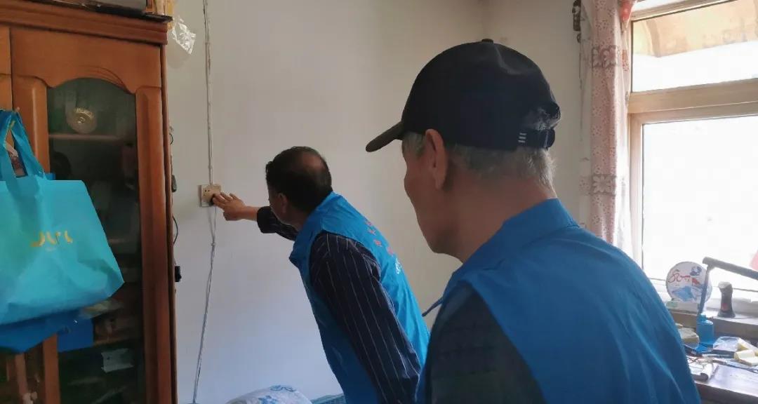 “居民安全防护队”对老人家里用电安全进行排查.jpg
